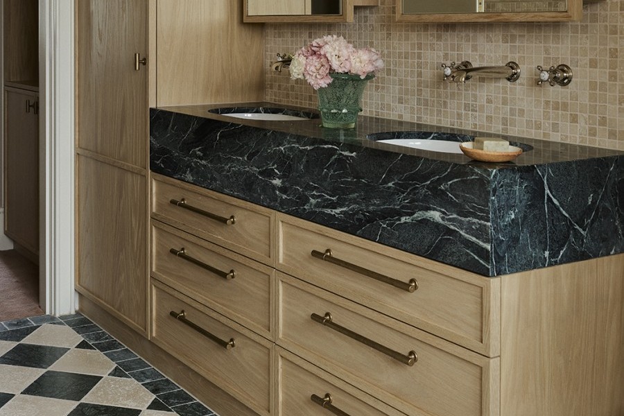 A green marble topped vanity featuring Perrin & Rowe wall mounted classic nickel tapware and aged brass drawer hardware from Armac Martin. 
