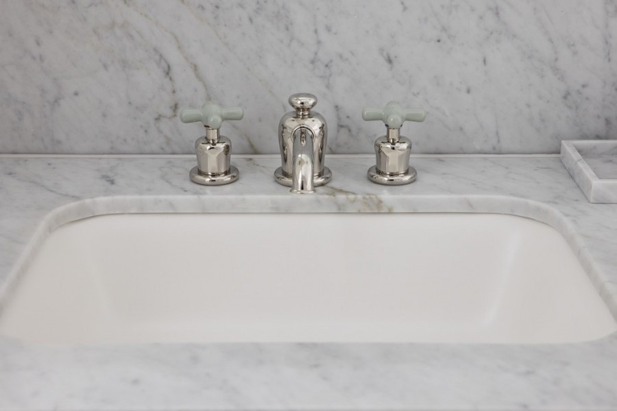 Guest ensuites featuring polished nickel tapware with Rockwell finishes, including Seattle Grey and Willow Green, creating cohesive yet distinctive bathroom designs.