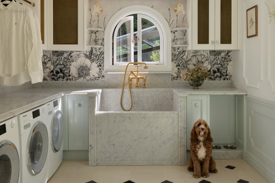 In the laundry, the use of a polished brass Perrin & Rowe bath mixer with hand shower and crosshead taps is cleverly used to introduce a refined sense of luxury to a traditionally utilitarian space. 