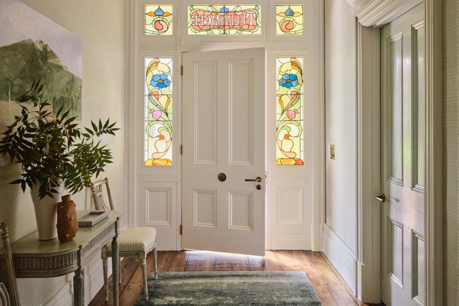 The entrance hall at Warrnambool House sets the stage for the home’s design. Satin brass hardware by Joseph Giles adds a touch of refined luxury.
