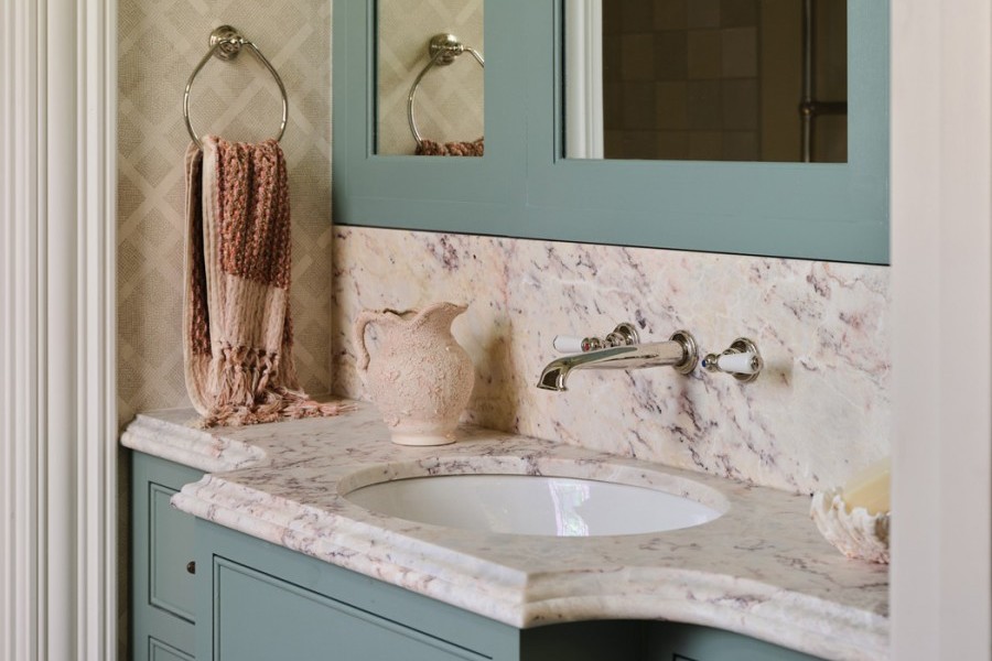 Kids’ bathroom with blue vanity and custom mirror, Perrin & Rowe taps with white porcelain lever handles, and a cohesive, playful design.
