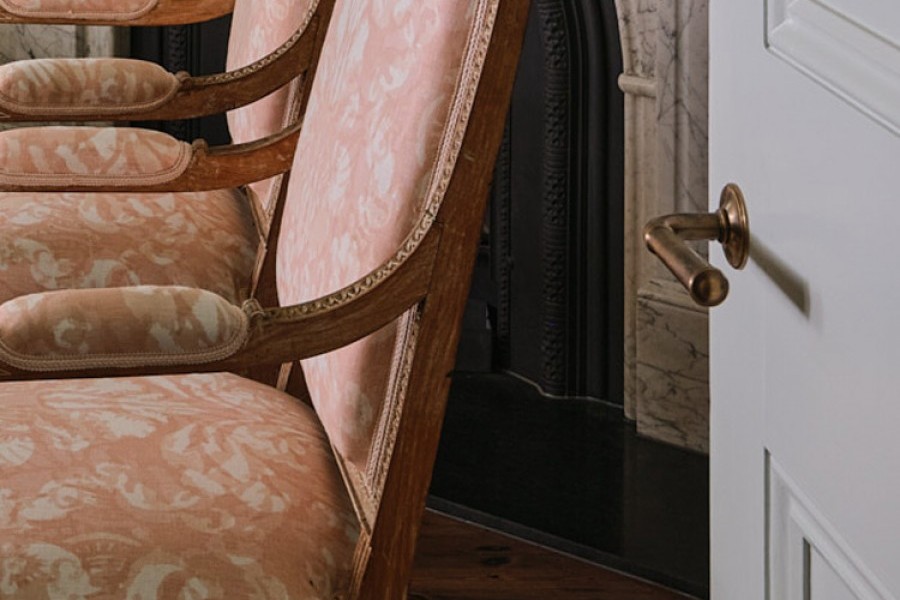 Delicate floral prints are layered with Joseph Giles brass lever handles