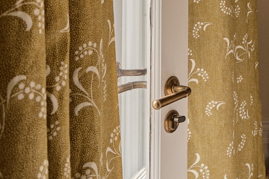 Master bedroom with yellow and pink accents that tie into master ensuite and with citrus kitchen feature the Darlington door levers by Joseph Giles