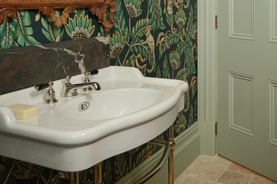 Green accents and feature wallpaper set against the soft white porcelain of the Paris basin with Hawthorn Hill basin stand