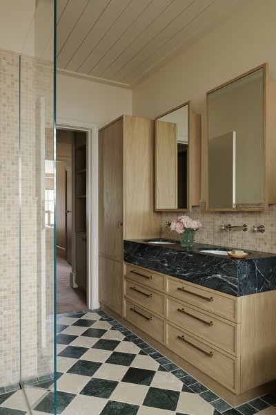 A bathroom with green and white checkerboard tiles and vanity featuring Perrin & Rowe traditional nickel tapware and aged brass drawer hardware from Armac Martin. 