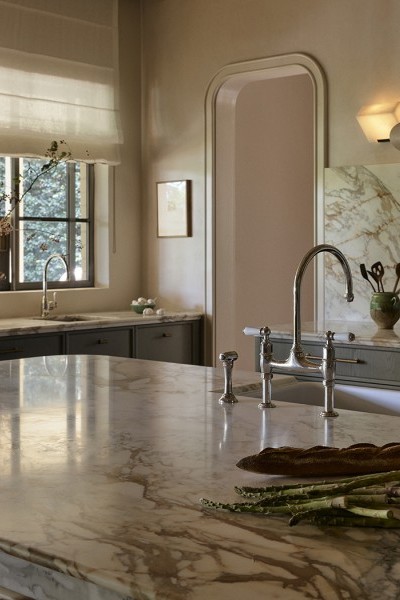 A kitchen with marble bench and Perrin & Rowe nickel tapware from The English Tapware Company. 