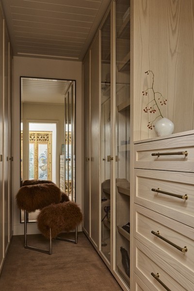A walk in wardrobe with Armac Martin brass cabinet pulls from The English Tapware Company. 