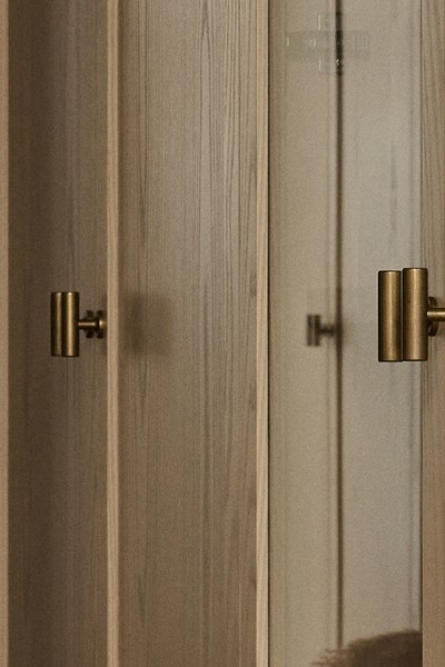 A walk in wardrobe with Armac Martin brass t-bars from The English Tapware Company. 