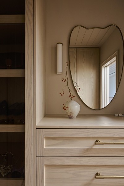 An ensuite master wardrobe with Armac Martin brass cabinetry hardware from The English Tapware Company. 