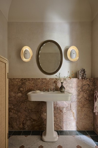 A WC with pink marble with white classic basin from The Water Monopoly and Polished Nickel traditional  
Perrin & Rowe hot and cold taps and mixer.