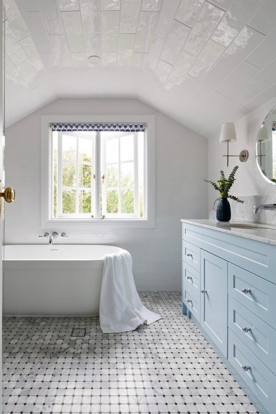 Chrome Art Deco wall-mounted bath taps with lever handles and chrome bathroom accessories in bathroom fitout.
