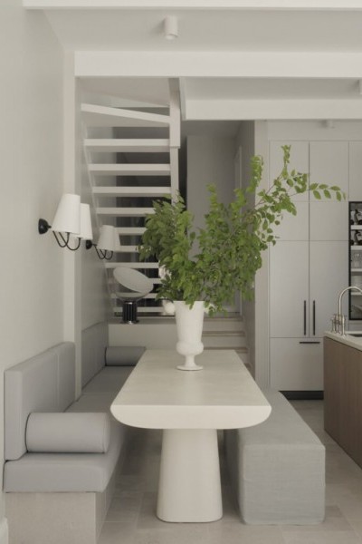 Kitchen banquette seating in soft grey, stone table and timber kitchen with nickel kitchen tap.