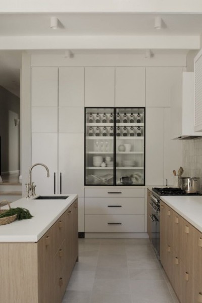 Timber kitchen with white tiled splash back, white cabinetry and nickel kitchen tap and spray. 