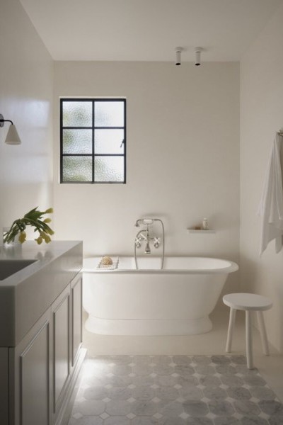 Bathroom with freestanding bath, custom cabinetry and nickel tapware.