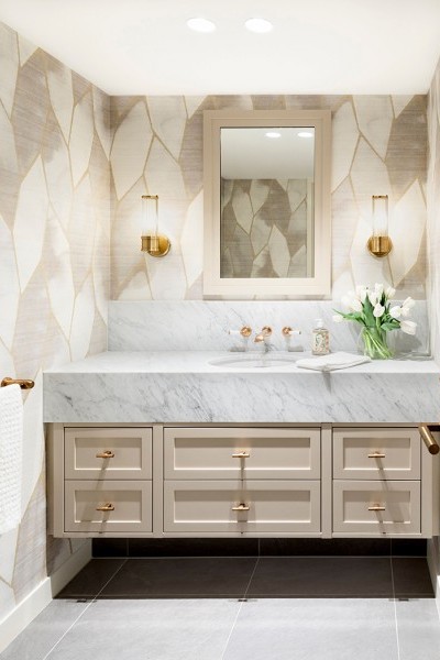 Traditional brass taps, towel rail, and t-bar drawer handles bring glamour to this elegant bathroom.
