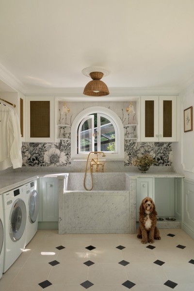 In the laundry, the use of a polished brass Perrin & Rowe bath mixer with hand shower and crosshead taps is cleverly used to introduce a refined sense of luxury to a traditionally utilitarian space. 
