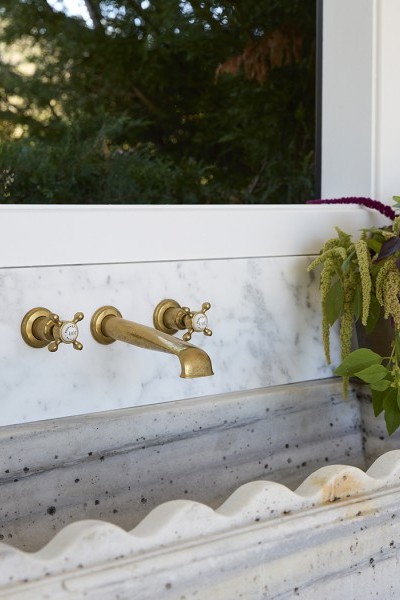 The polished brass taps and bathroomware in Steve Cordony's renovated pool house show the beginnings of aging patination.
