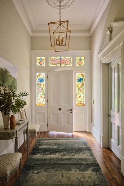 The entrance hall at Warrnambool House sets the stage for the home’s design. Satin brass hardware by Joseph Giles adds a touch of refined luxury.