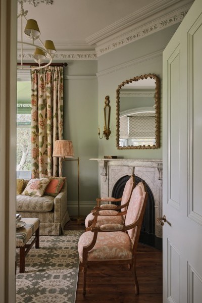 Delicate floral prints are layered with Joseph Giles brass lever handles