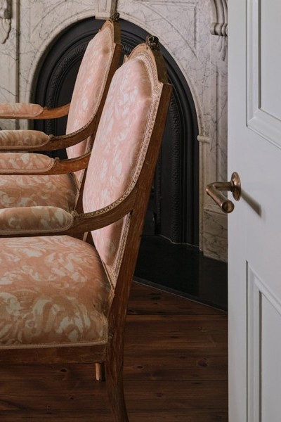 Delicate floral prints are layered with Joseph Giles brass lever handles