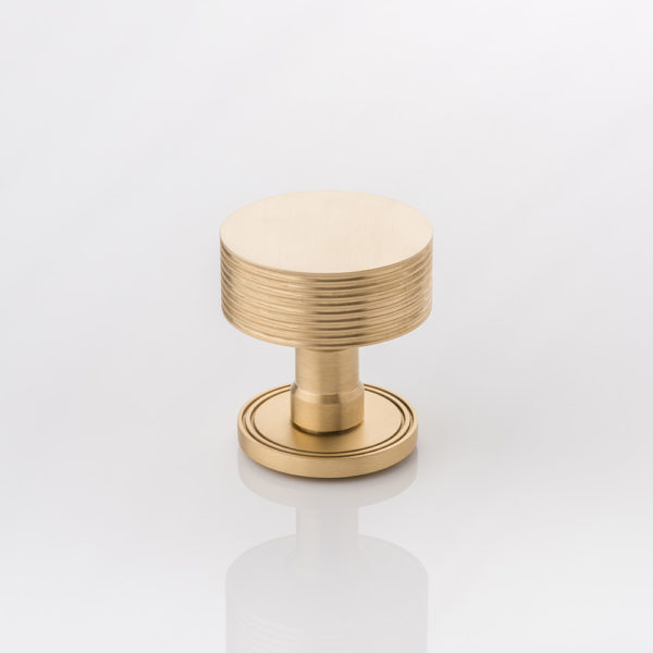 Arnett II solid brass door knob with grooved rose