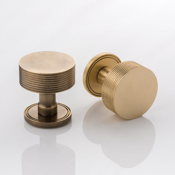 Arnett II solid brass door knob with grooved rose