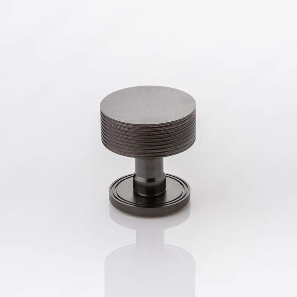 Arnett II solid brass door knob with grooved rose