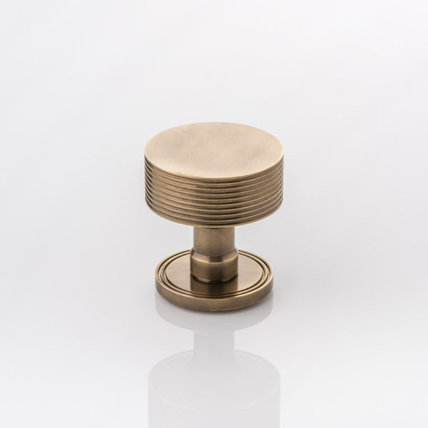 Arnett II solid brass door knob with grooved rose