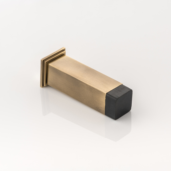 Cube solid brass wall-mounted door stopper with decorative stepped plate