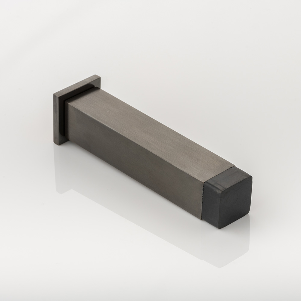 Cube II solid brass wall-mounted door stopper with decorative stepped plate