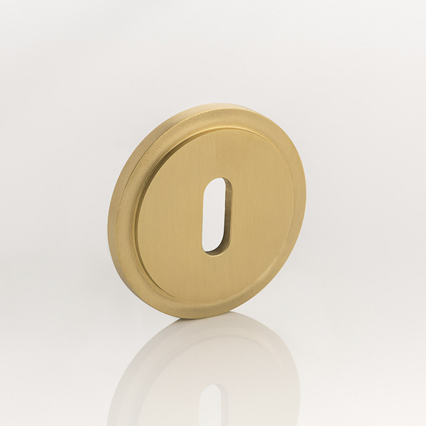 Solid brass keyhole profile round stepped escutcheon