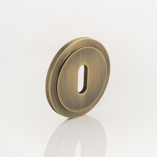 Solid brass keyhole profile round stepped escutcheon