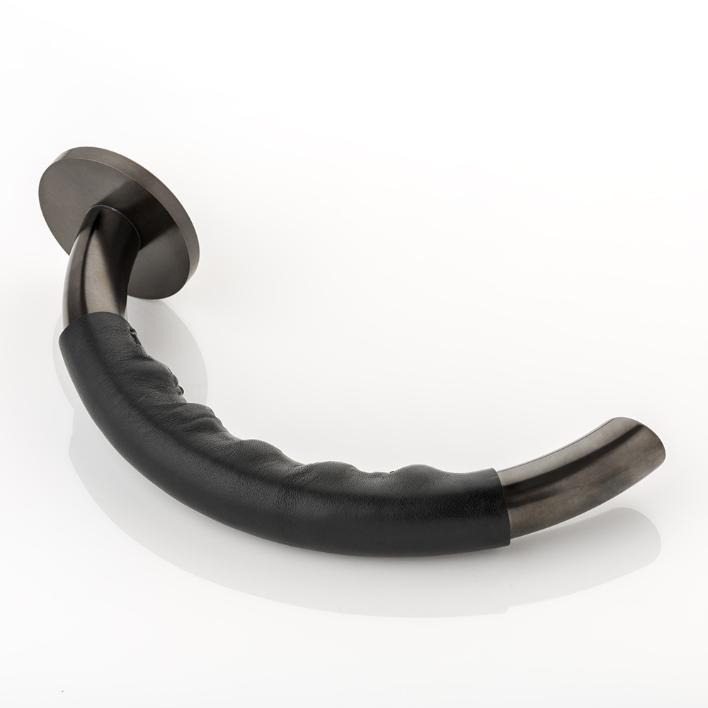 Infinity II solid brass door lever handle with hand stitched leather & round rose